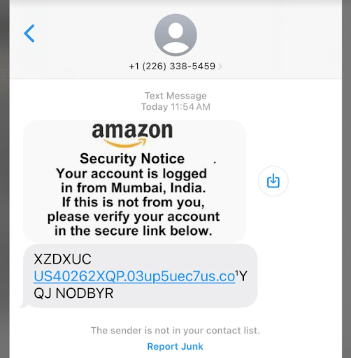 A screenshot of a text message from an unknown sender. The message claims to be from Amazon, warning about an account login from Mumbai, India, and urges the recipient to verify their account via a provided link.