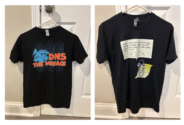 Left image: Black t-shirt with a graphic of a cartoon character and text "DNS THE MENACE." Right image: Black t-shirt with a graphic of a talking paperclip and a dialogue box saying, "Looks like...like to add some to it?" with "Yes" and "No" options.